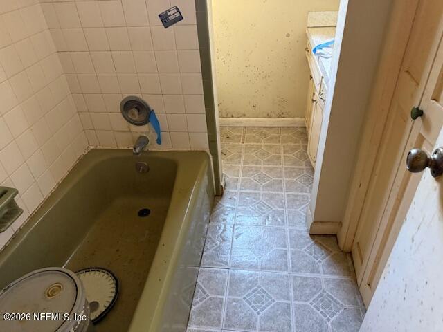 8002 Lenox Avenue Jacksonville, FL 32221 - Photo 13 of 20 a bathroom with a tub and a shower