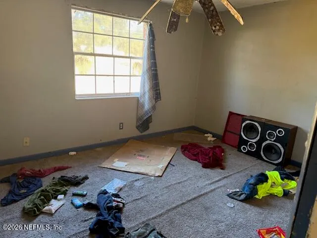 a view of a room with furniture and a window