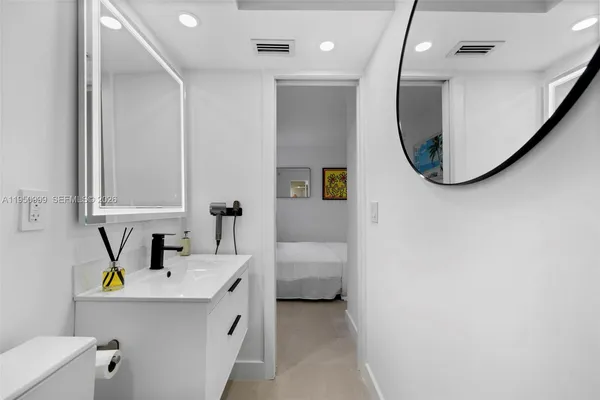 a bathroom with a sink vanity and a mirror