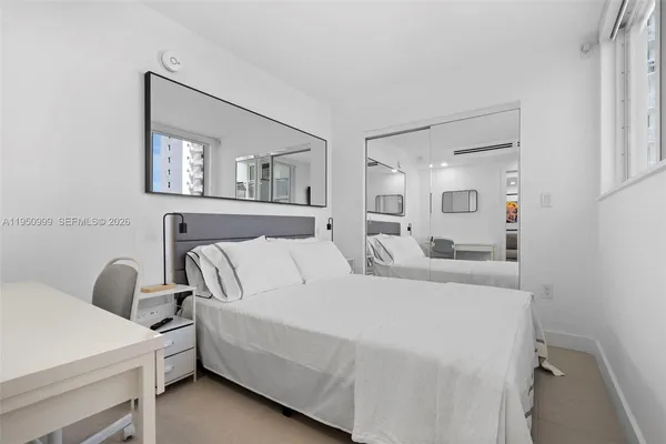 a bed room with a bed and a painting