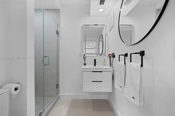 a bathroom with a mirror a sink and a mirror