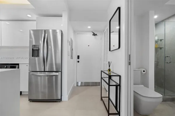 a kitchen with stainless steel appliances granite countertop a refrigerator and a sink