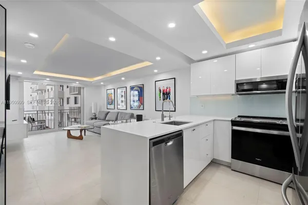 a kitchen with a sink a stove and cabinets