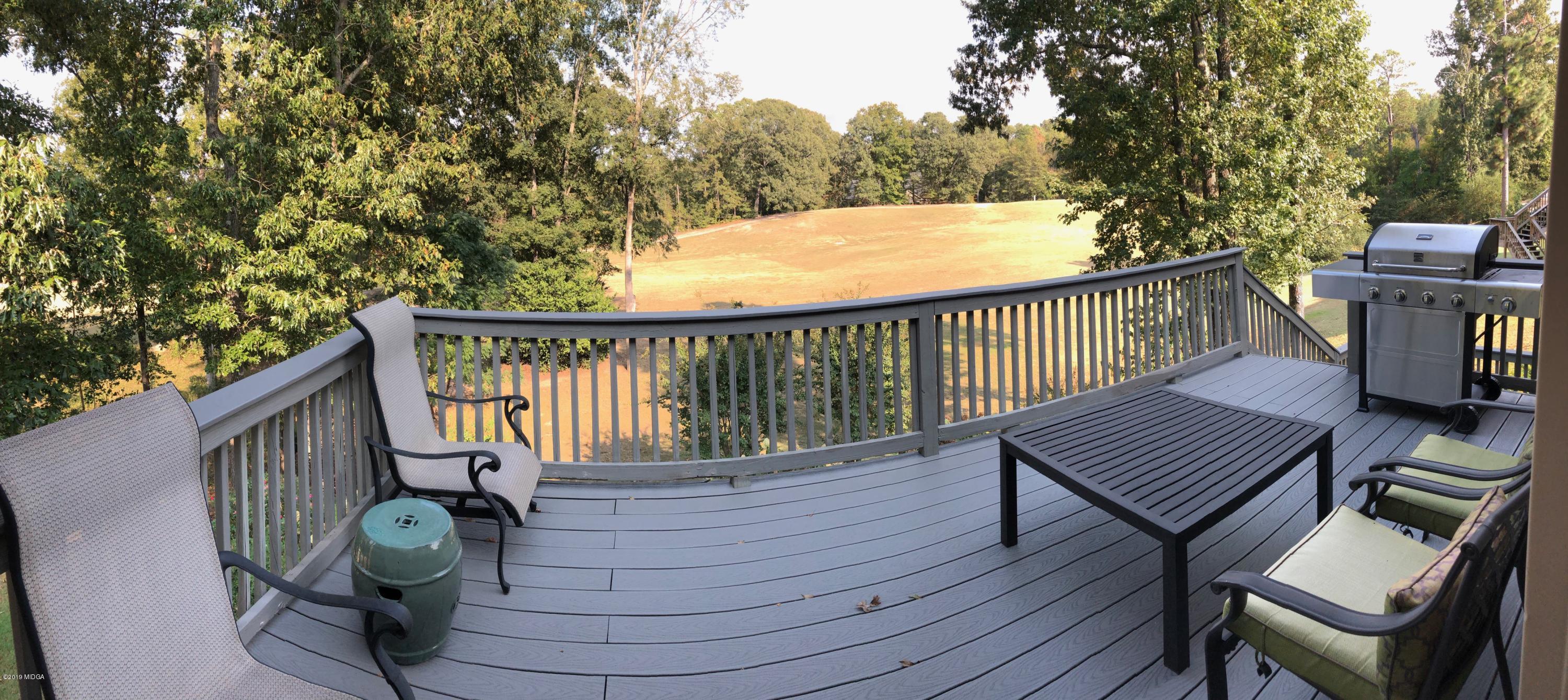 351 Eagle Ridge Road Macon, GA 31216 - Photo 14 of 33 a view of balcony with wooden floor outdoor seating and trees