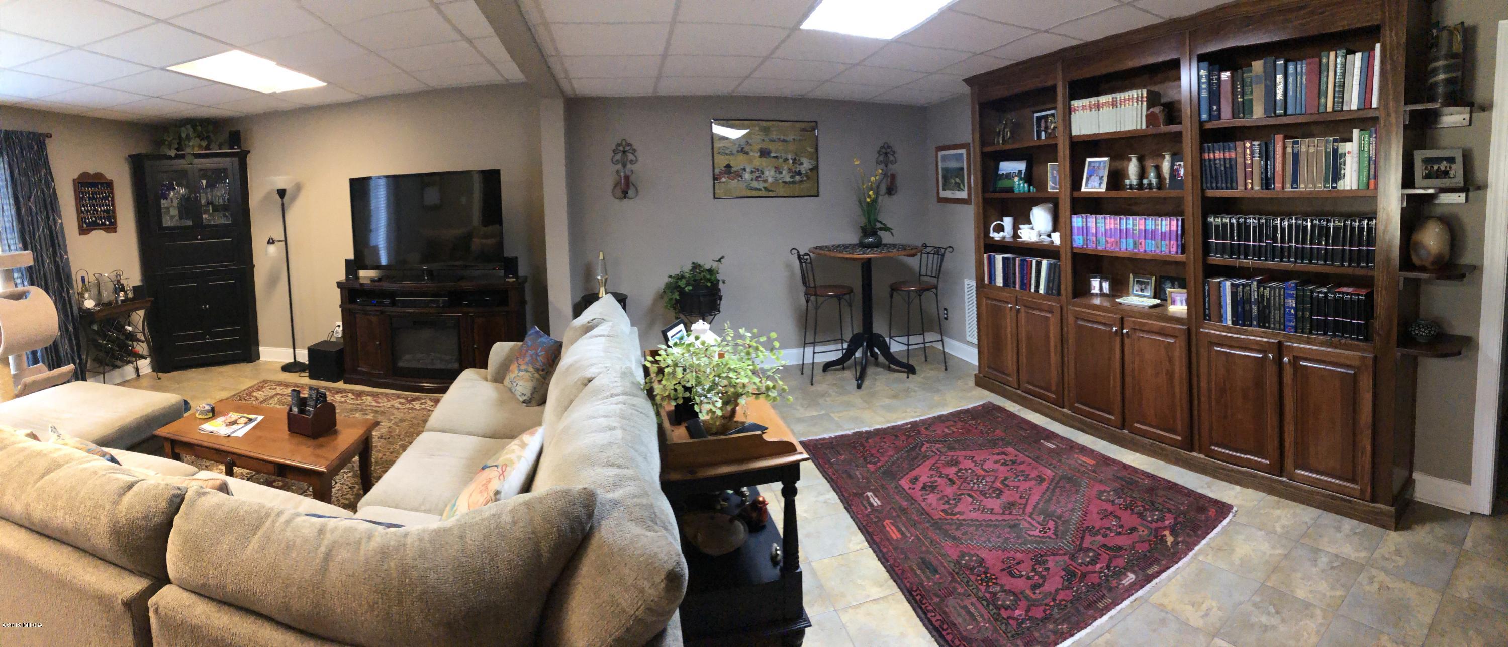 351 Eagle Ridge Road Macon, GA 31216 - Photo 25 of 33 a living room with furniture and a book shelf
