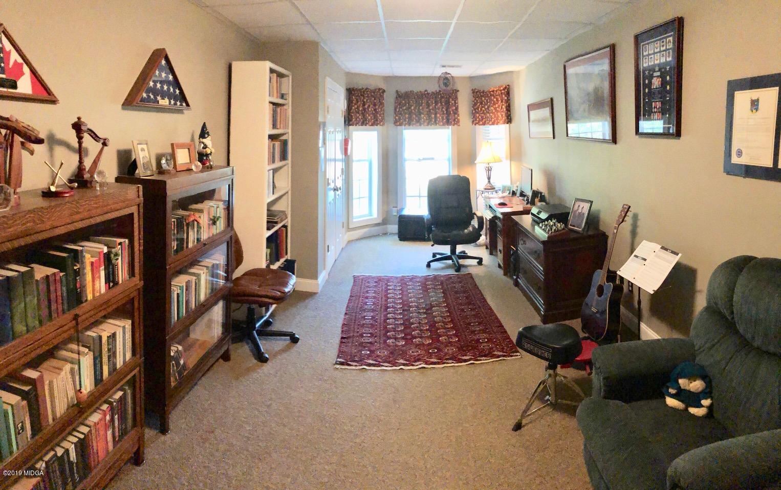 351 Eagle Ridge Road Macon, GA 31216 - Photo 29 of 33 a living room with furniture a bookshelf and a window