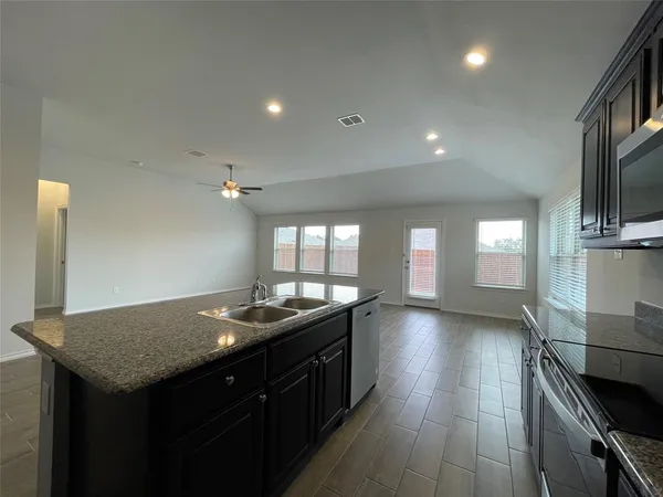 a kitchen with sink stove and cabinets
