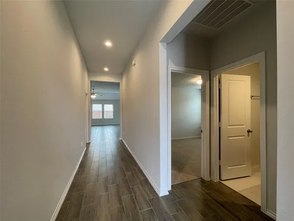 a view of hallway with wooden floor