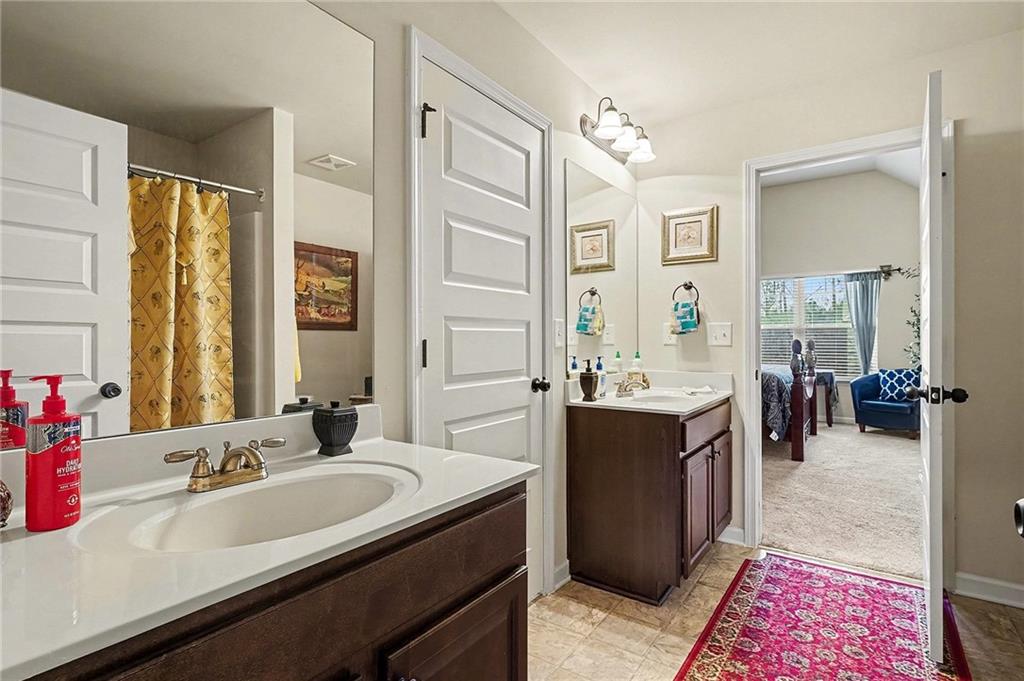 90 Waters Edge Lane Covington, GA 30014 - Photo 17 of 18 a spacious bathroom with a bathtub sink and mirror