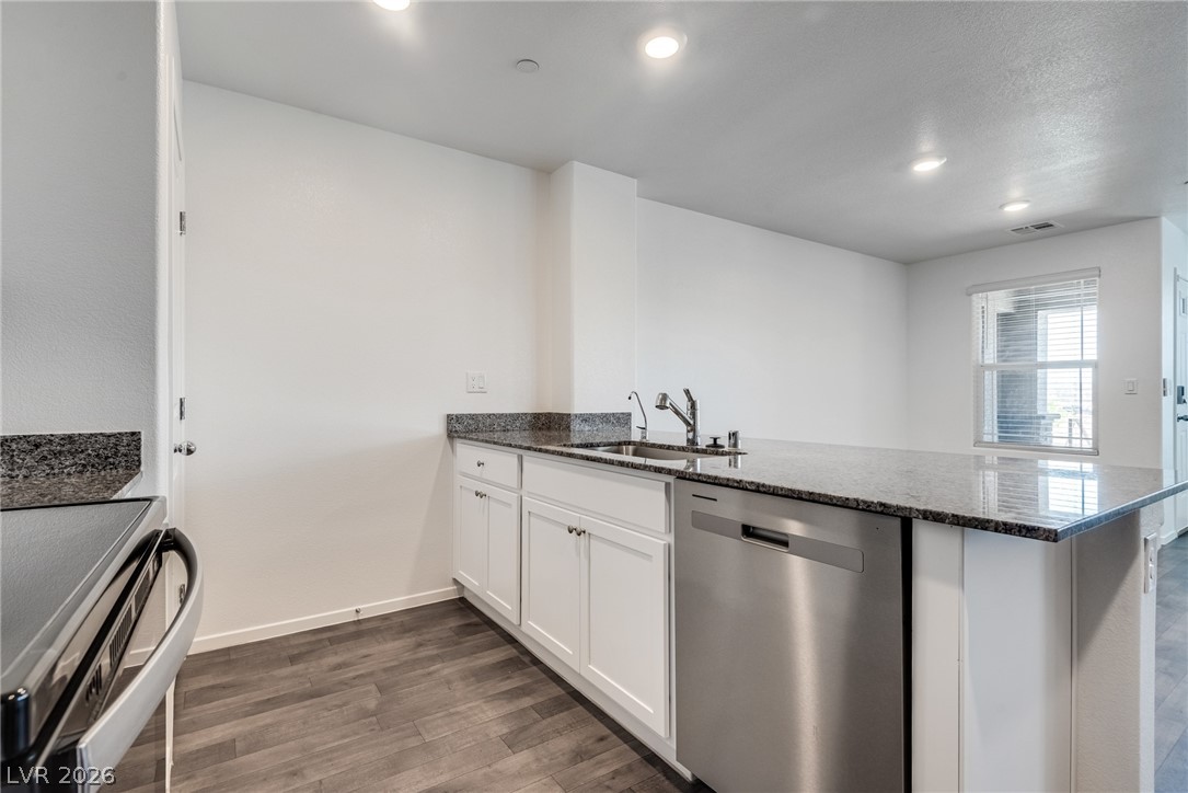 1114 Scarlet Sparrow Street Henderson, NV 89011 - Photo 12 of 25 A well-appointed culinary space featuring granite counters and modern stainless steel appliances.