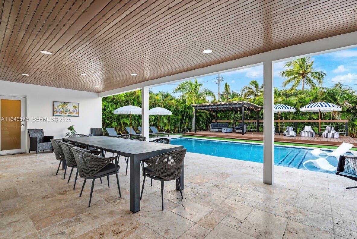 5111 Adams Street Hollywood, FL 33021 - Photo 12 of 66 a view of a patio with table and chairs next to a yard