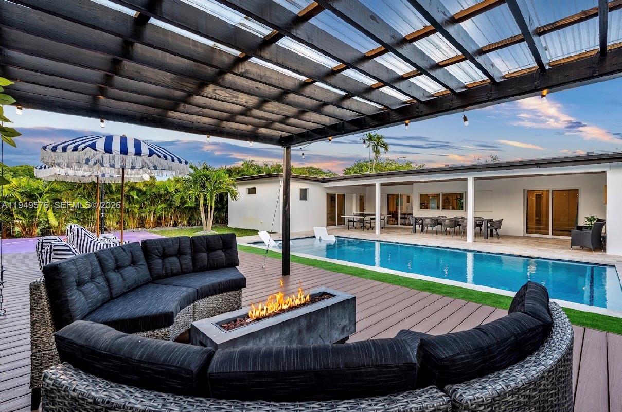 5111 Adams Street Hollywood, FL 33021 - Photo 14 of 66 a view of a patio with couches chairs and wooden floor