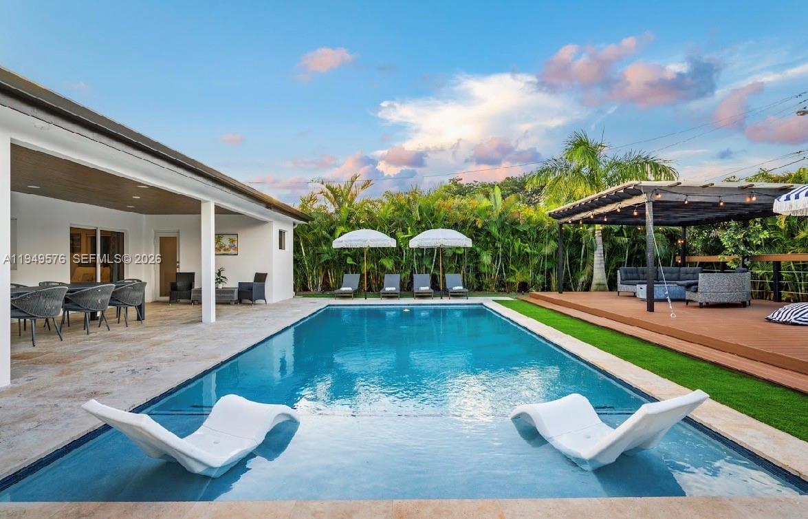 5111 Adams Street Hollywood, FL 33021 - Photo 16 of 66 a view of a swimming pool with sitting area