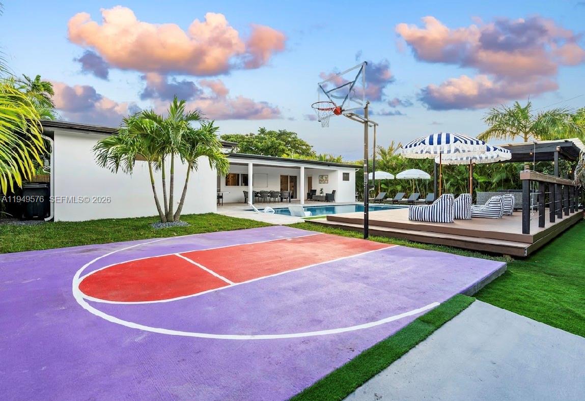 5111 Adams Street Hollywood, FL 33021 - Photo 23 of 66 a view of a basketball court with a house in the background