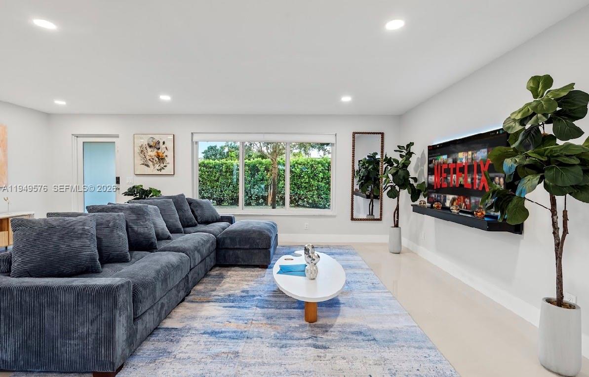5111 Adams Street Hollywood, FL 33021 - Photo 26 of 66 a living room with furniture and a flat screen tv