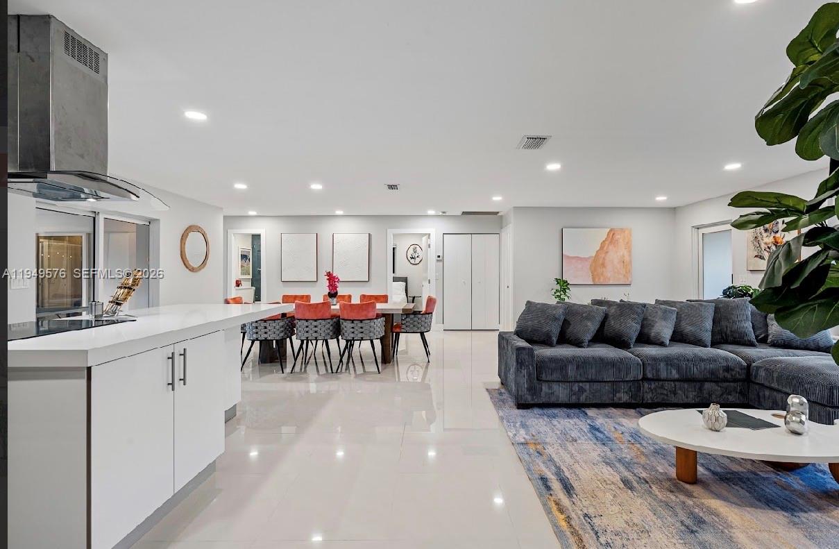 5111 Adams Street Hollywood, FL 33021 - Photo 27 of 66 a living room with furniture and a table