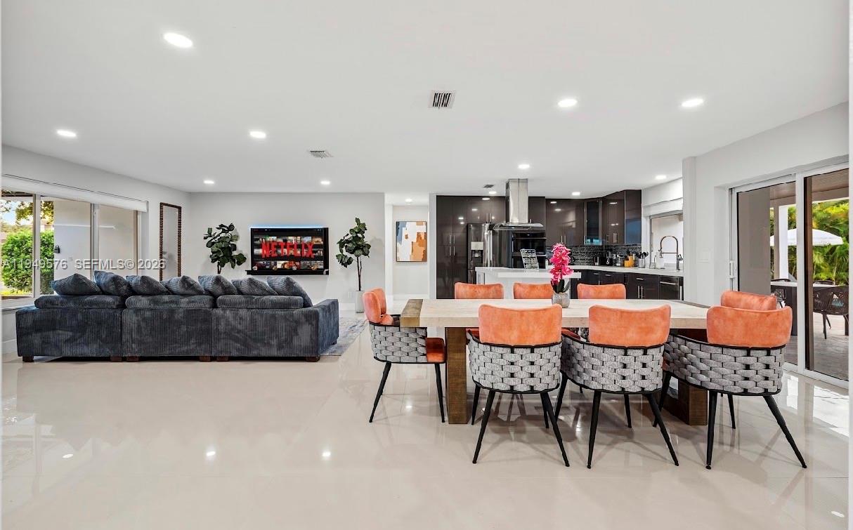 5111 Adams Street Hollywood, FL 33021 - Photo 31 of 66 a living room with furniture and a flat screen tv