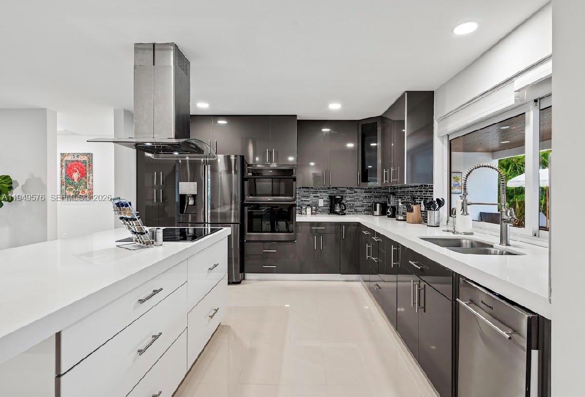 5111 Adams Street Hollywood, FL 33021 - Photo 33 of 66 a kitchen with refrigerator and cabinets