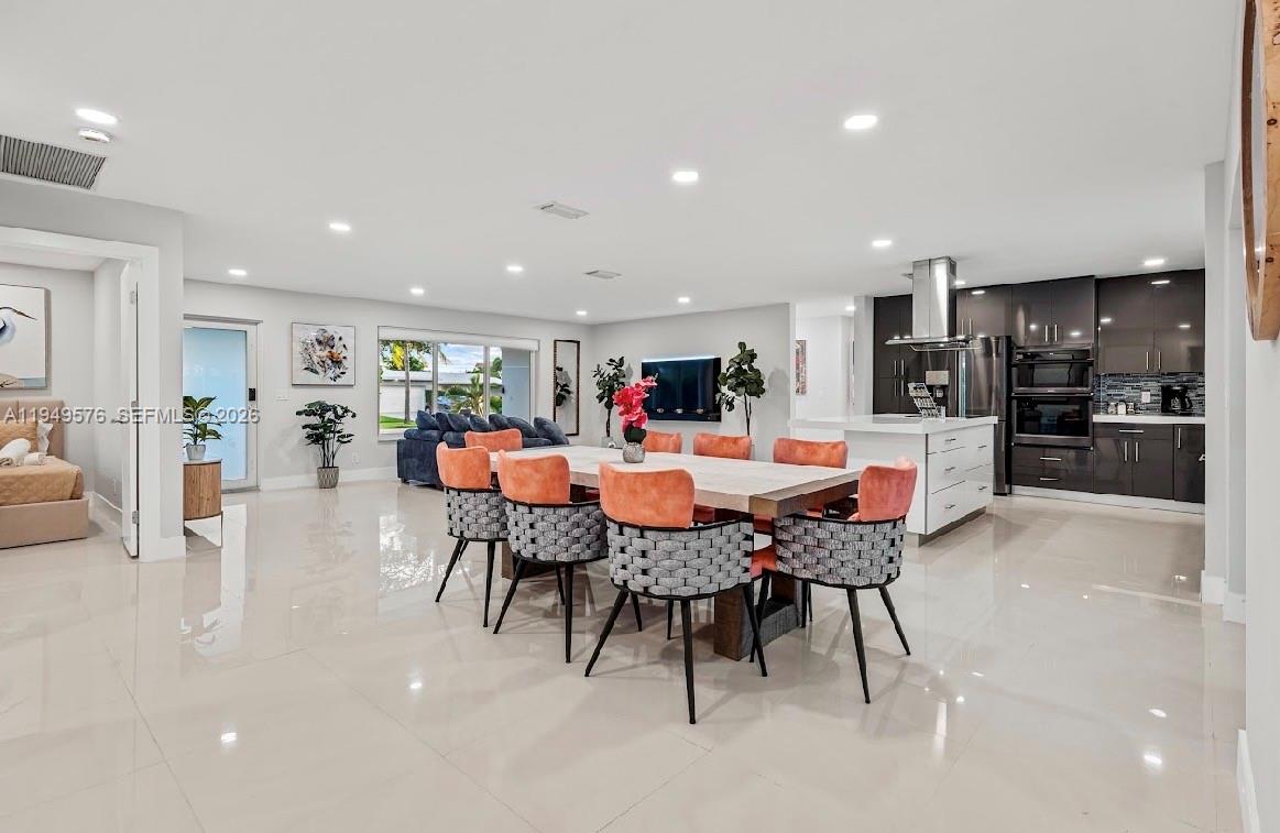 5111 Adams Street Hollywood, FL 33021 - Photo 34 of 66 a kitchen with a dining table chairs and view kitchen