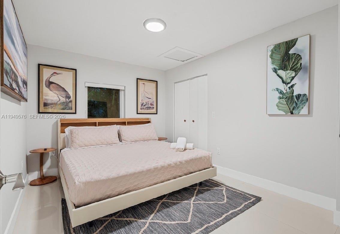 5111 Adams Street Hollywood, FL 33021 - Photo 39 of 66 a bedroom with a bed and a painting on the wall