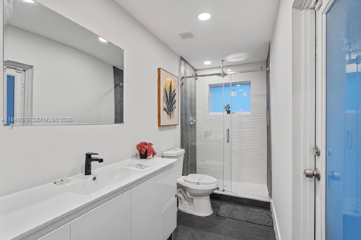 5111 Adams Street Hollywood, FL 33021 - Photo 40 of 66 a bathroom with a sink toilet and shower