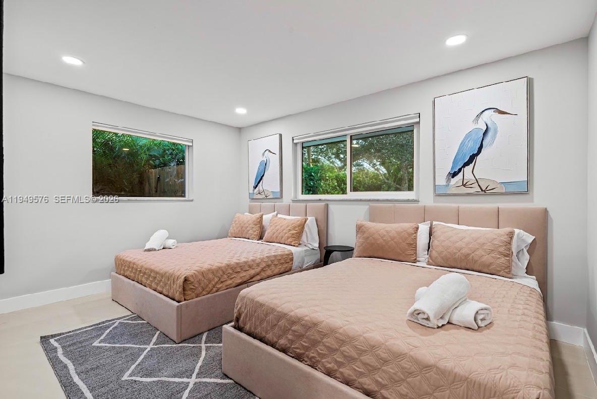 5111 Adams Street Hollywood, FL 33021 - Photo 42 of 66 a bedroom with two beds and a painting