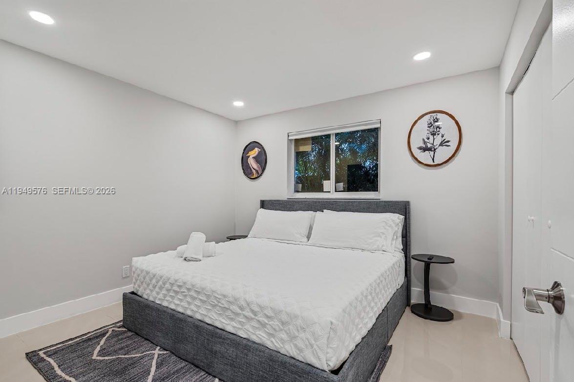 5111 Adams Street Hollywood, FL 33021 - Photo 43 of 66 a bedroom with a bed and a wall painting