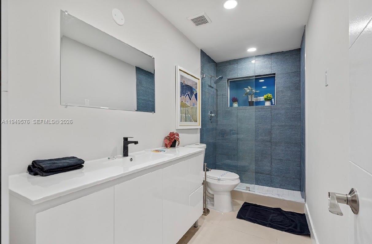 5111 Adams Street Hollywood, FL 33021 - Photo 45 of 66 a bathroom with a sink a toilet and a shower