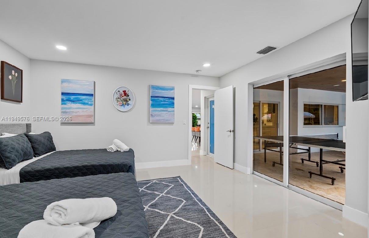 5111 Adams Street Hollywood, FL 33021 - Photo 47 of 66 a bedroom with furniture and a large window