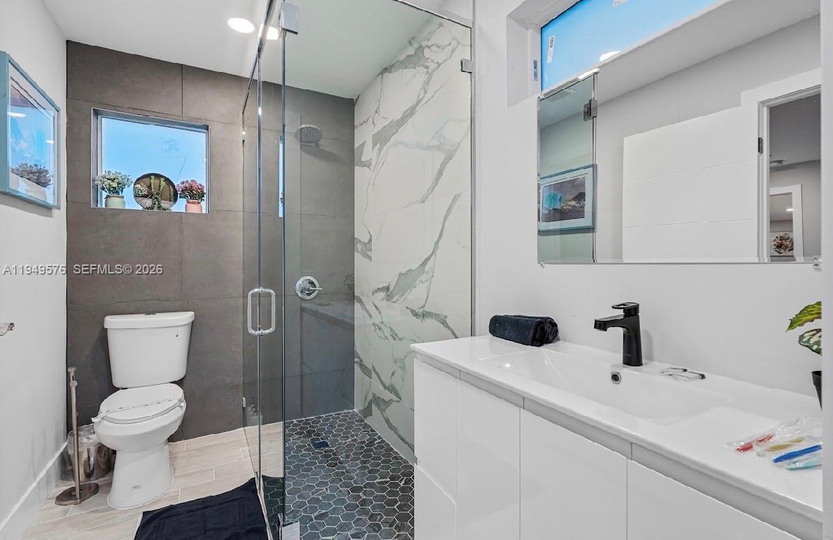5111 Adams Street Hollywood, FL 33021 - Photo 48 of 66 a bathroom with a sink a toilet and shower