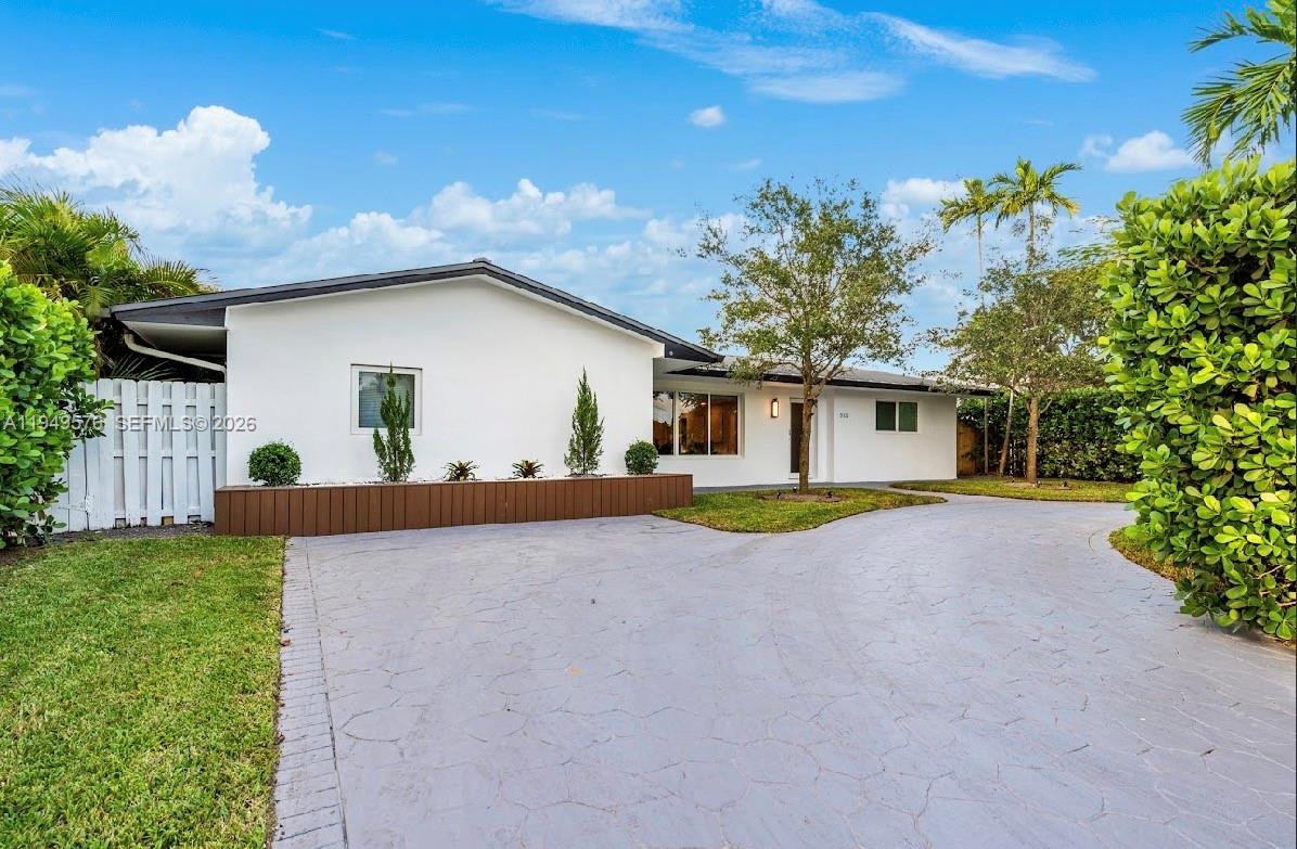 5111 Adams Street Hollywood, FL 33021 - Photo 53 of 66 a front view of a house with a yard and garage