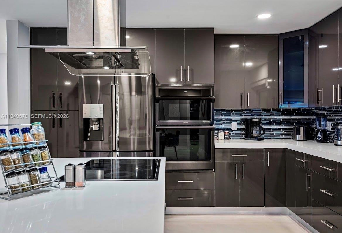 5111 Adams Street Hollywood, FL 33021 - Photo 56 of 66 a kitchen with stainless steel appliances granite countertop a refrigerator and a stove