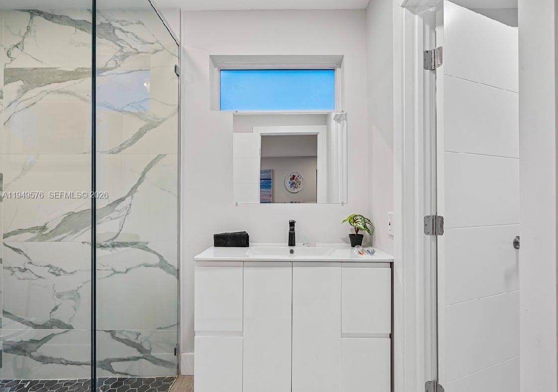 5111 Adams Street Hollywood, FL 33021 - Photo 57 of 66 a bathroom with a sink and a mirror