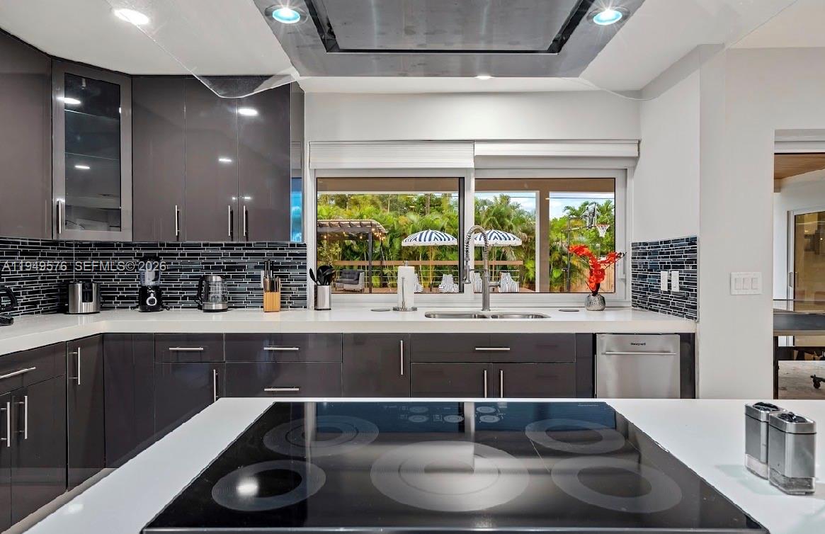 5111 Adams Street Hollywood, FL 33021 - Photo 58 of 66 a kitchen with kitchen island granite countertop a sink and a stove