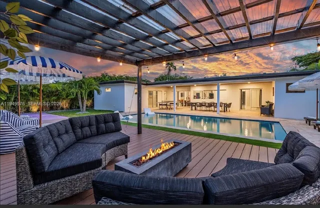 a view of swimming pool with outdoor seating