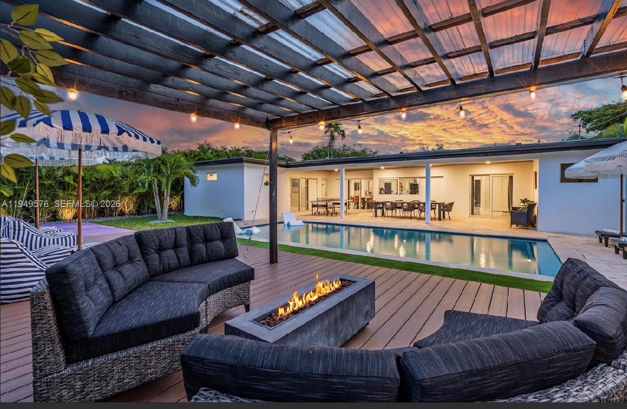 5111 Adams Street Hollywood, FL 33021 - Photo 6 of 66 a outdoor living space with furniture and a ceiling fan