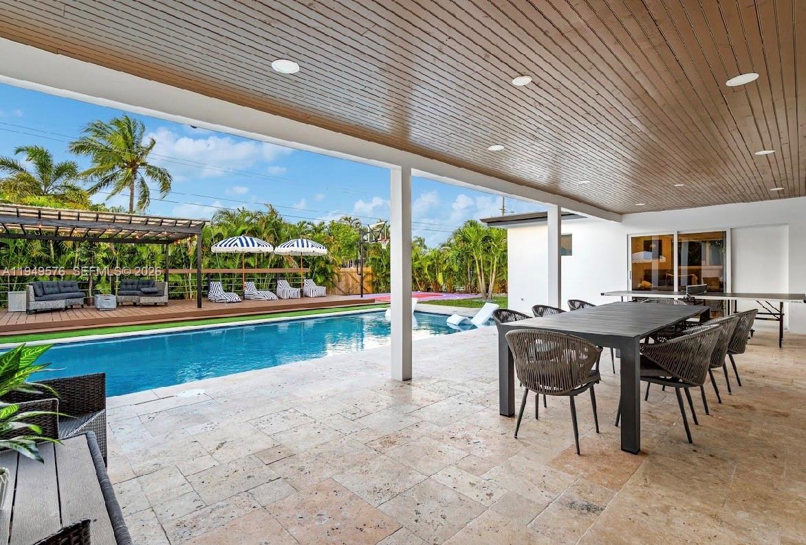 5111 Adams Street Hollywood, FL 33021 - Photo 10 of 66 a view of a patio with a table chairs and a patio