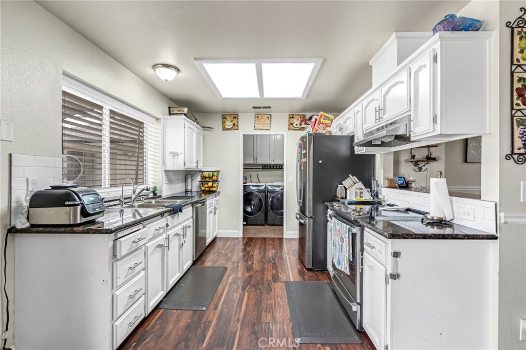 19729 Brightwood Road Madera, CA 93638 - Photo 11 of 33 a kitchen with stainless steel appliances granite countertop a stove and a sink