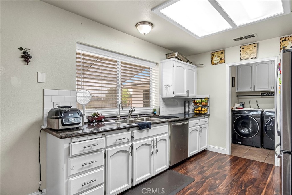 19729 Brightwood Road Madera, CA 93638 - Photo 12 of 33 a kitchen with a sink stove top oven and cabinets