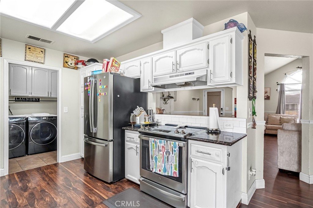 19729 Brightwood Road Madera, CA 93638 - Photo 13 of 33 a kitchen with stainless steel appliances granite countertop a refrigerator a stove and a sink