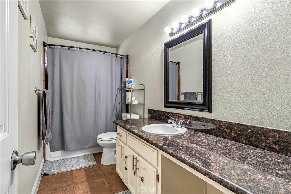 19729 Brightwood Road Madera, CA 93638 - Photo 16 of 33 a bathroom with a granite countertop sink mirror vanity and toilet