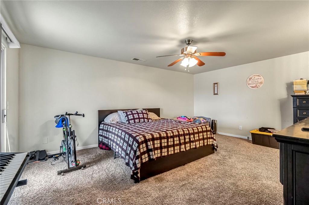 19729 Brightwood Road Madera, CA 93638 - Photo 23 of 33 a living room with a bed furniture and a window