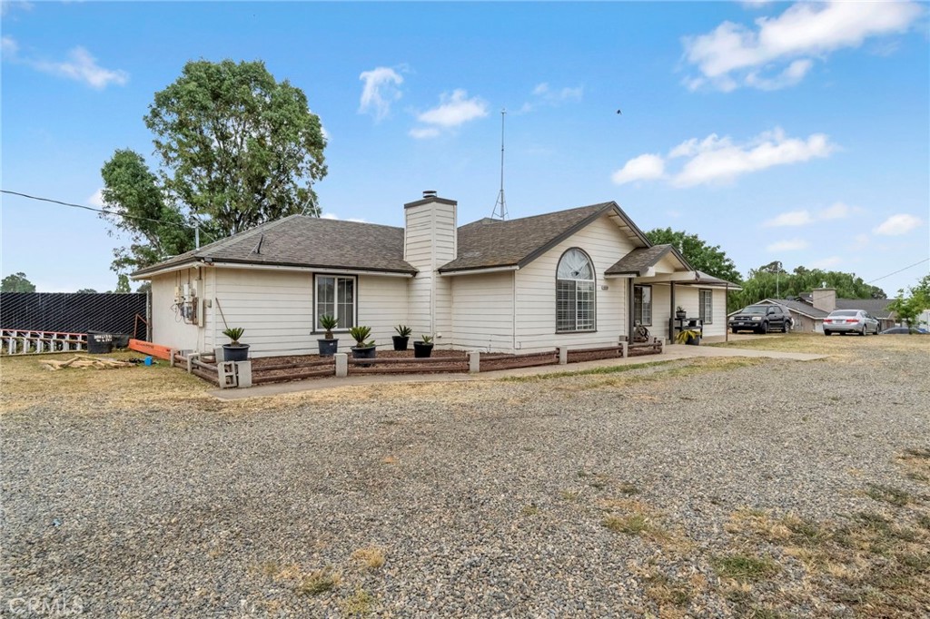19729 Brightwood Road Madera, CA 93638 - Photo 3 of 33 a view of a house with a backyard and a tree