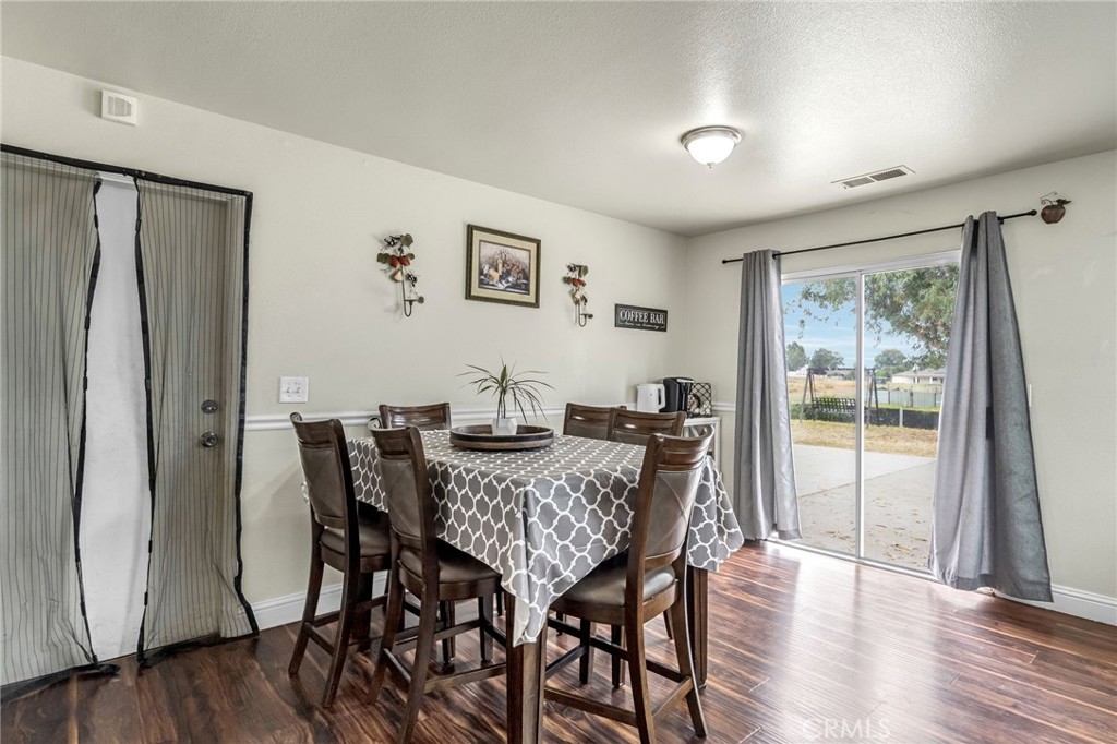 19729 Brightwood Road Madera, CA 93638 - Photo 9 of 33 a view of a dining room with furniture window and wooden floor