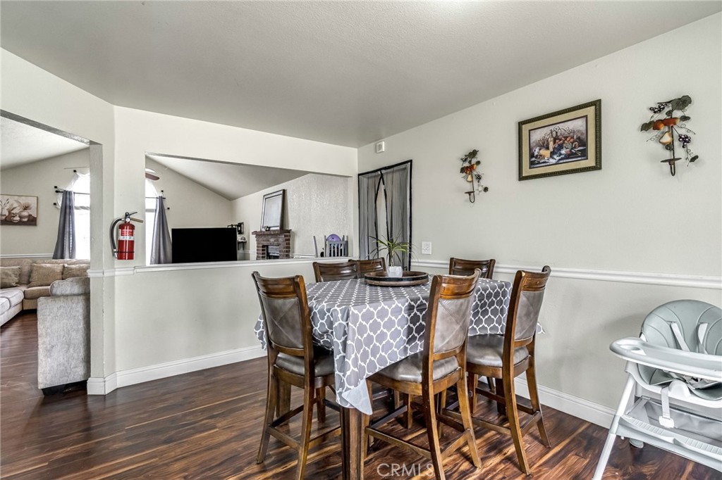 19729 Brightwood Road Madera, CA 93638 - Photo 10 of 33 a view of a dining room with furniture and wooden floor