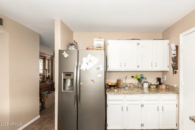 a kitchen with stainless steel appliances granite countertop a sink a stove and cabinets