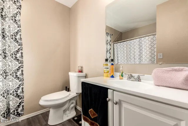 a bathroom with a toilet and a shower curtain