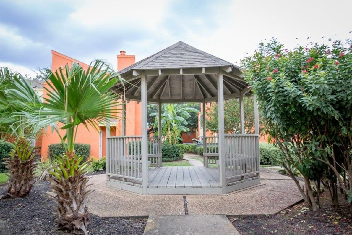2801 North Broadmead, Unit 1107 Houston, TX 77025 - Photo 13 of 15 a patio with a table and chairs under an umbrella