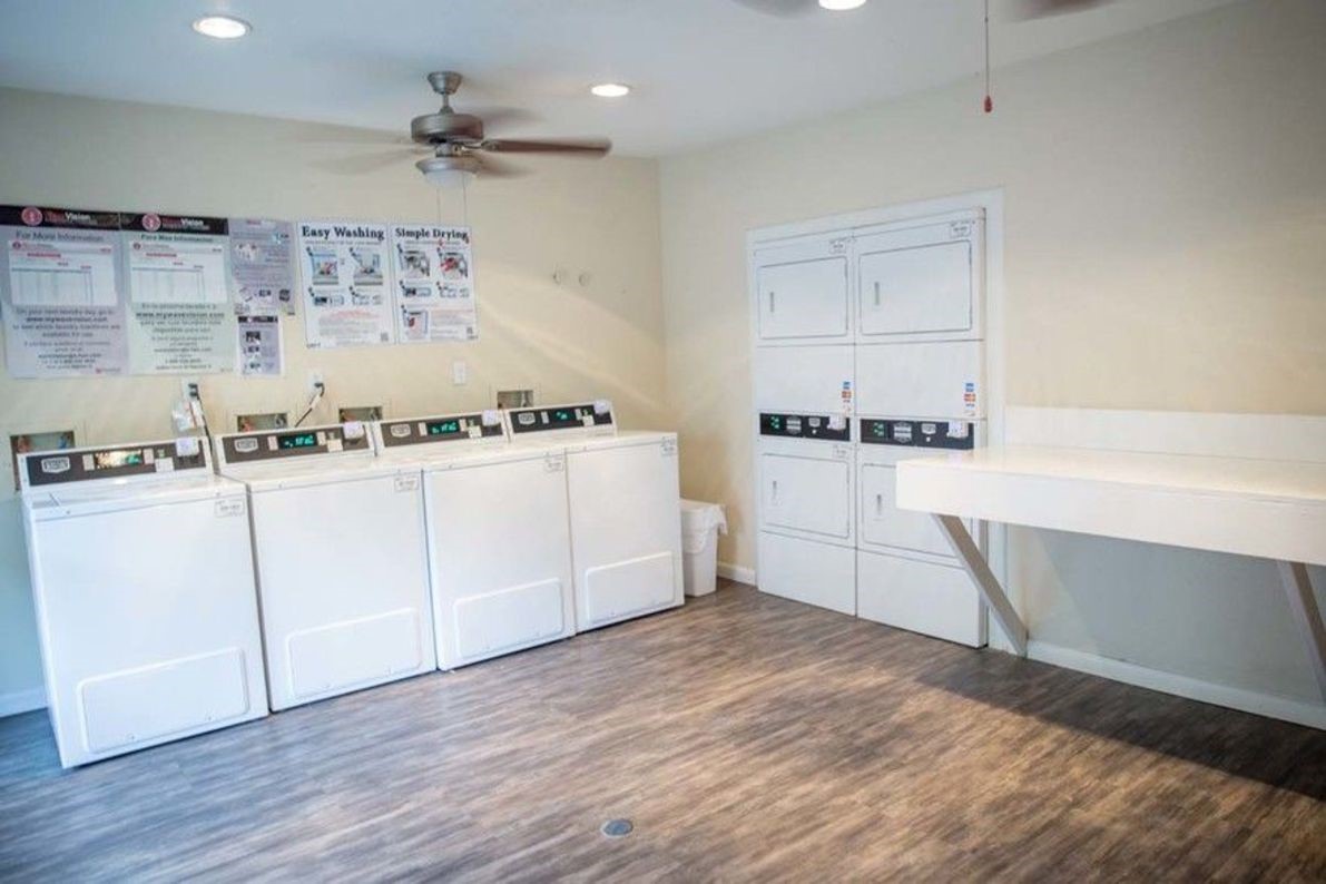 2801 North Broadmead, Unit 1107 Houston, TX 77025 - Photo 14 of 15 a kitchen with stainless steel appliances a sink a stove a refrigerator and cabinets