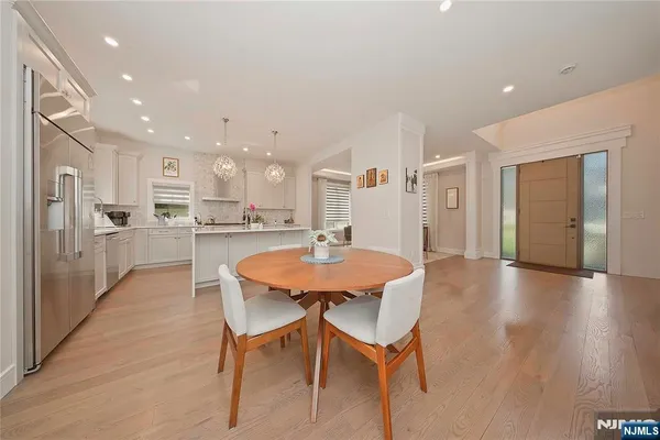 a large kitchen with a table and chairs